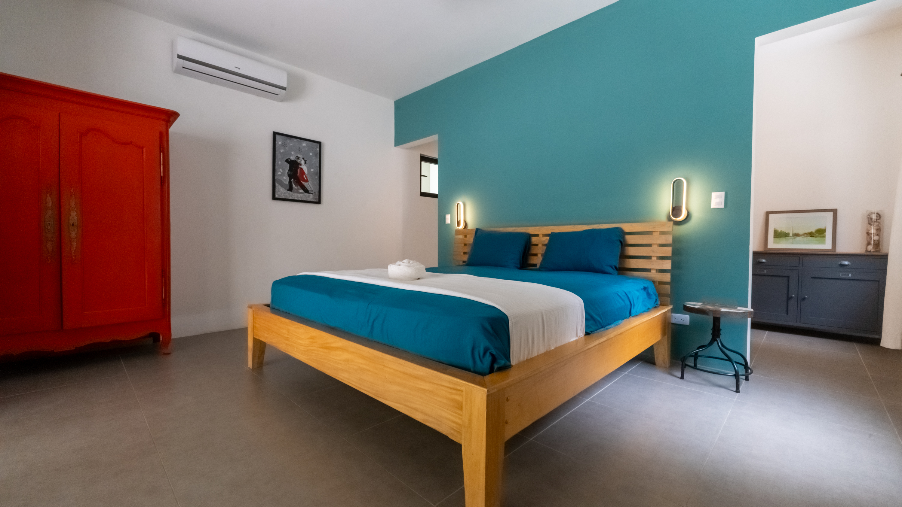 modern bedroom with blue wall inside villa for sale samara costa rica